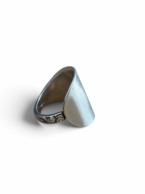 Smitsjewellery silver statement ring with an elongated polished surface and intricate side engravings.