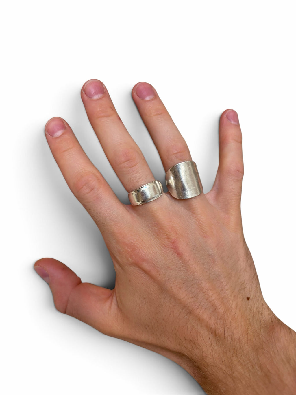 Smitsjewellery silver statement rings worn on a hand, featuring a polished elongated design and a smooth band.
